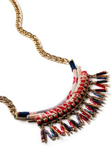 close up of short bib necklace with wrapped chirimen ribbons, beaded dangles, and bright gold chain