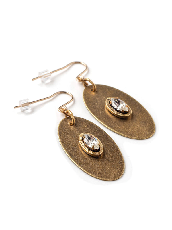 Three quarter closeup view of modern oval drop earrings in antique gold with rhinestone navette accents