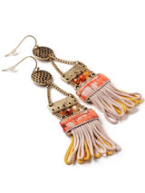closeup view of ladder style earrings with ribbon detail and tassels
