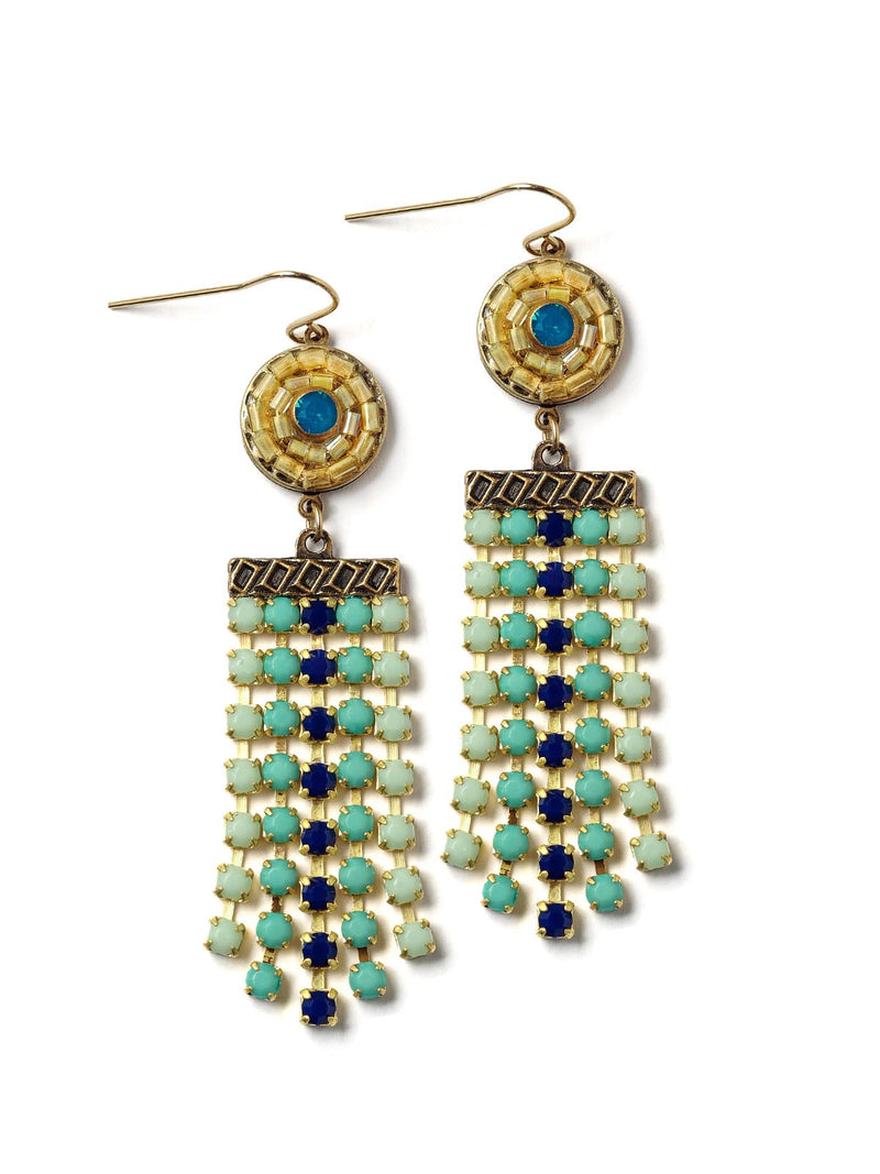top-down view of colorful fringe earrings with beaded tops and blue centers